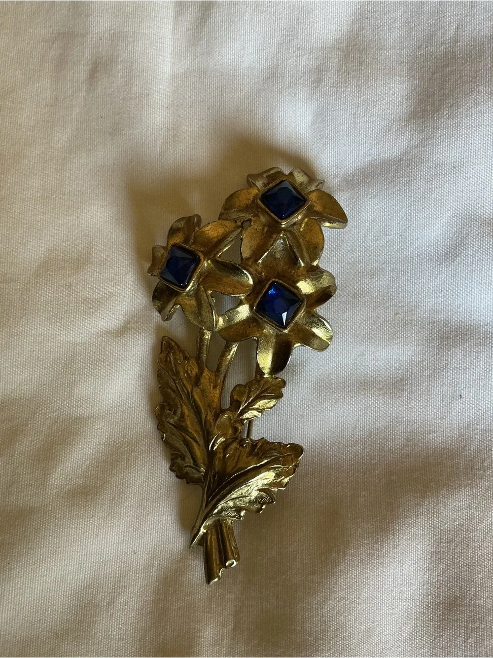Gold Tone Floral Brooch with Blue Glass Stones